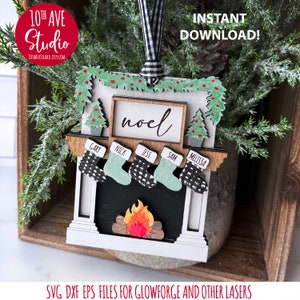 May include: White wooden Christmas ornament shaped like a fireplace with a green garland, stockings with names, and a sign that says "noel".