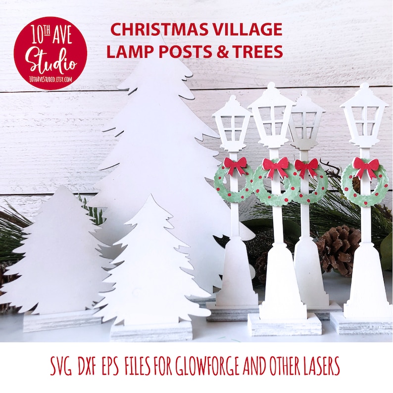May include: White cutout Christmas village lamp posts and trees with wreaths. SVG, DXF, and EPS files for Glowforge and other lasers. 10th Ave Studio.