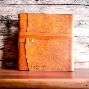This is our 8x8 leather photo album or guest book in rust personalized on the cover.  Our custom photo albums are perfect for memories, used as a scrapbook or wedding guestbook