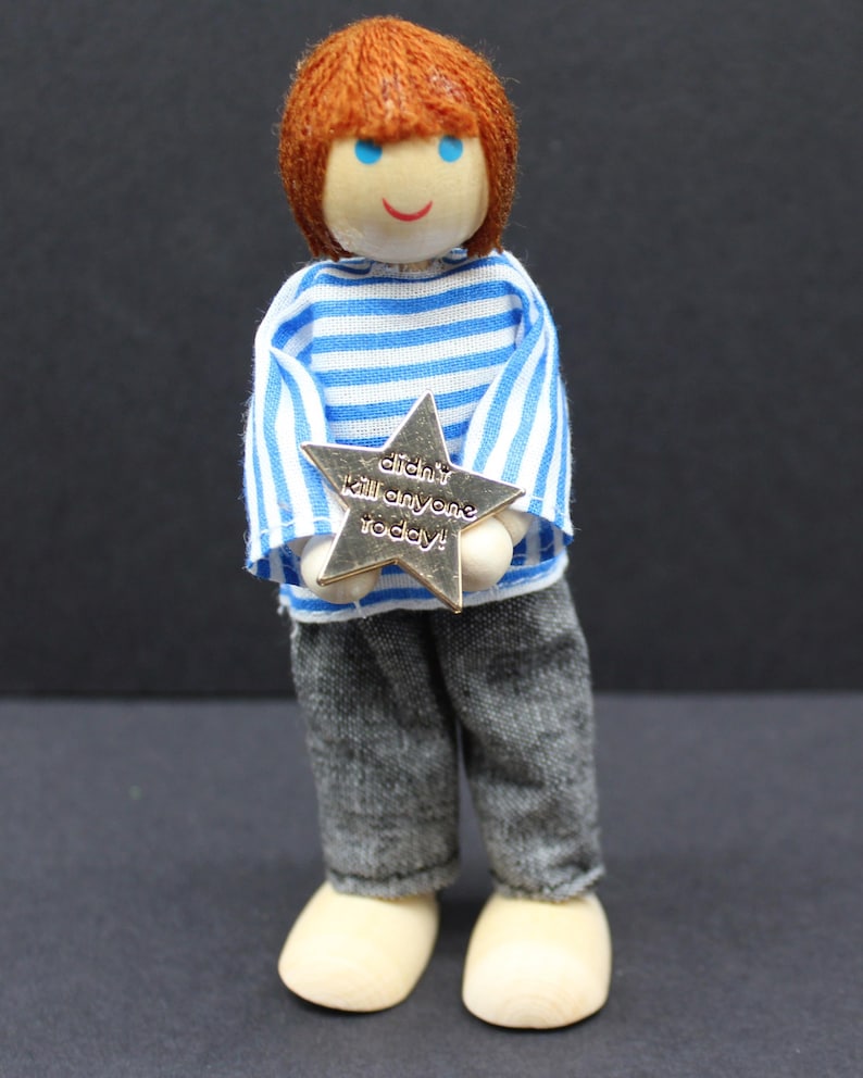 Gold star enamel pin attached to a doll’s jacket, showing playful scale. Humour badge for work stress or neurodivergent support gift, funny enamel pin for adults, sarcastic motivational reward.