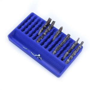 May include: A blue plastic organizer with a grid of slots to hold various sized screwdriver bits. The organizer is filled with a variety of screwdriver bits.