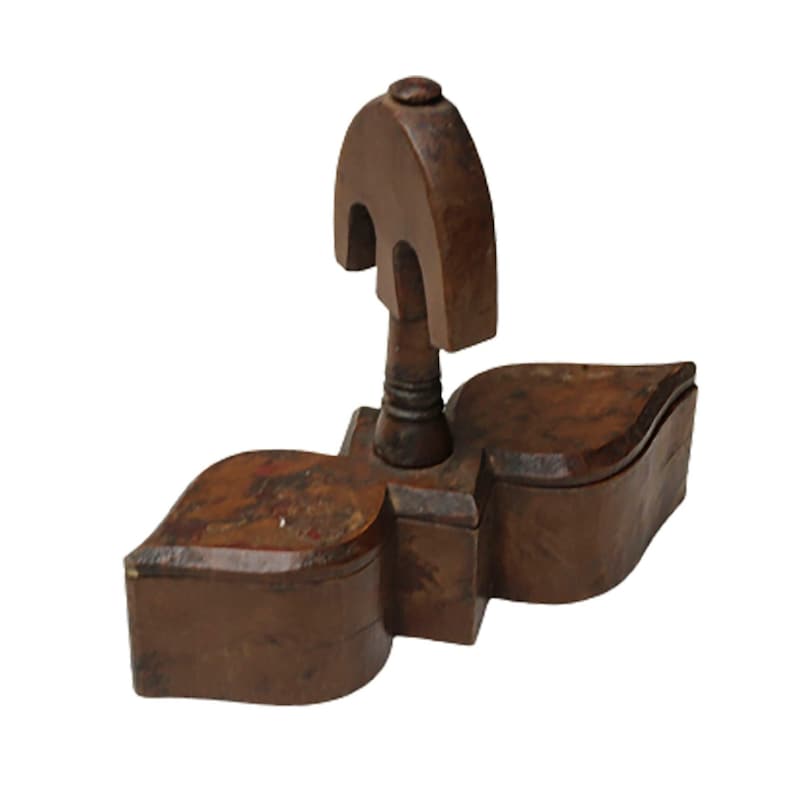 May include: A wooden box with a unique design. The box is made of dark brown wood and has a carved top. The box is divided into two compartments.