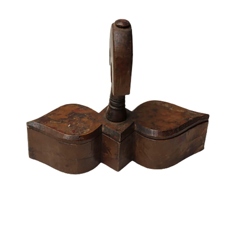 May include: A wooden box with a unique design. The box is divided into two sections and has a decorative handle on top. The box is made of dark brown wood and has a rustic appearance.