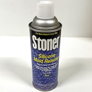 May include: A silver can of Stoner Silicone Mold Release, a product that prevents parts from sticking. The can is labeled with the product name and instructions for use. It is 12 ounces (341 g).