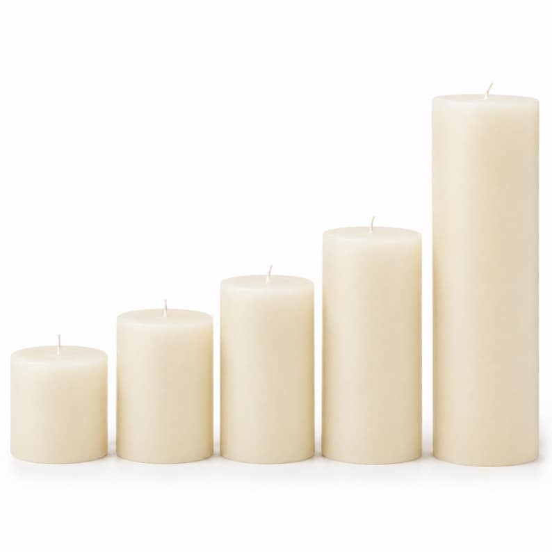 May include: Five ivory-colored pillar candles of varying heights, arranged in a row. Each candle has a wick at the top. The candles are cylindrical and have a smooth, solid appearance, suitable for home decor or events.