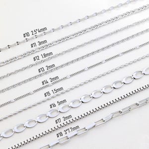 May include: A collection of silver-colored chain necklaces in various styles. The image displays different chain designs, including oval links, box chains, and beaded styles. Each chain is labeled with a number and measurement, such as "#10 2.5*4mm".