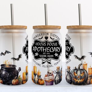 May include: Three frosted glass tumblers with bamboo lids and metal straws, featuring Halloween-themed graphics including a black cauldron, a jack-o'-lantern, a skull, bats, and candles, with text reading Sanderson Sisters Hocus Pocus Apothecary.