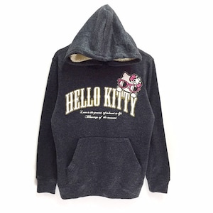May include: A gray hooded sweatshirt with a Hello Kitty graphic on the front. The graphic features Hello Kitty wearing sunglasses and the text "Hello Kitty" in gold lettering. The text "Love is the greatest refreshment in life. The blessing of the moment." is printed below the graphic.