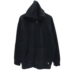 May include: A black hooded sweatshirt with a zipper closure. The sweatshirt has a kangaroo pocket and a drawstring hood.