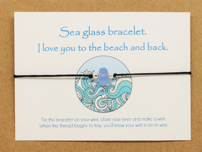May include: A sea glass bracelet with a blue glass bead and black string. The card reads "Sea glass bracelet. I love you to the beach and back. Tie this bracelet on your wrist, close your eyes and make a wish. When the thread begins to fray, you'll know your wish is on its way."
