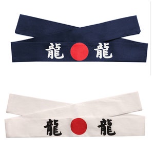 May include: Two fabric headbands with a red circle and the Japanese word "Dragon" written in white on a navy blue headband and in black on a white headband.