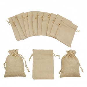 May include: Beige burlap drawstring bags. The image shows a fan of bags and a few individual ones. The bags are made of woven fabric, with a natural, rustic look. The bags have a drawstring closure.