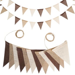 May include: Three burlap pennant banners in shades of brown and beige. The banners are strung on twine and are arranged in a layered design. The pennants are triangular and have a rustic, natural look.