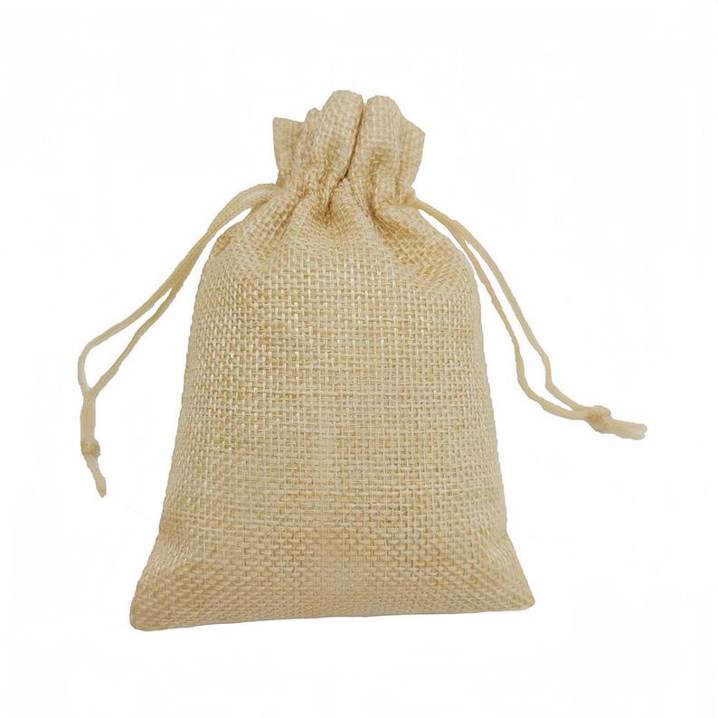 May include: A beige burlap drawstring bag. The bag is made from a woven fabric with a textured appearance. The top is gathered and secured with a drawstring. Ideal for small gifts or favours.