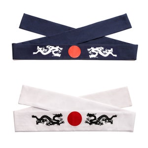 May include: Two fabric headbands with a red circle and white dragon design. One headband is navy blue and the other is white.