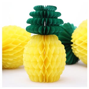 May include: A set of three yellow and green honeycomb paper pineapple decorations. The pineapples are made of tissue paper and have a three-dimensional honeycomb design.