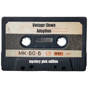Peut inclure: Une cassette audio en plastique noir avec une étiquette beige portant le texte Vintage Clown Adoption et mystery pick edition. L'étiquette comprend les inscriptions MK 60 6, Fe, M3K I et 1991, ainsi qu'une échelle numérique de 0 à 100.