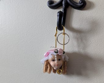 doll head keychain from Daysela's Small Little Shop of Strange and Unusual. Bisque Porcelain Doll Heads. Strange and Unusual Gift Shop.