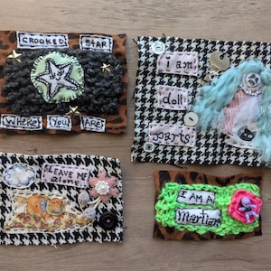 May include: A set of three ceramic mugs with a speckled, matte finish. The mugs are in shades of cream, light gray, and dark gray. Each mug has a simple, minimalist design, perfect for coffee or tea.