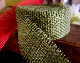 May include: Green burlap ribbon with a frayed edge. The ribbon is woven with a criss-cross pattern.