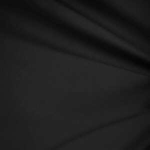 May include: A close-up of a black fabric with a subtle texture. The fabric is smooth and has a slight sheen.