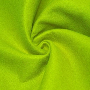 May include: A close-up of a bright green fabric with a soft, fuzzy texture. The fabric is folded and twisted, creating a swirling pattern.