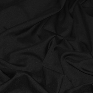May include: Black fabric with a smooth, wrinkle-free texture. The fabric is draped and folded, creating soft curves and folds.