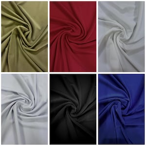 May include: A collection of six fabric swatches in various colors. The colors include olive green, deep red, white, light grey, black, and royal blue. The fabric is draped and swirled, showcasing its texture and drape.