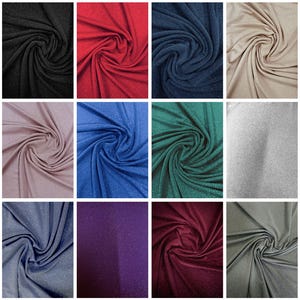 May include: A collection of swirled fabric samples in various colors, including black, red, navy blue, beige, mauve, blue, green, silver, dark blue, purple, burgundy, and gray. The fabric has a subtle glitter effect.