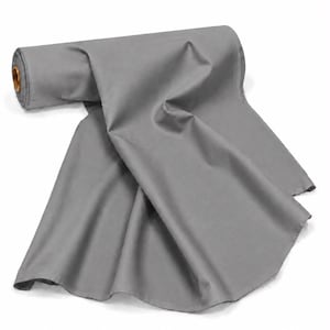 May include: A roll of solid medium gray fabric featuring a smooth, matte texture. The textile is partially unrolled, displaying soft folds and drapes that extend outward from the central cardboard core, which is visible at the left end of the roll.