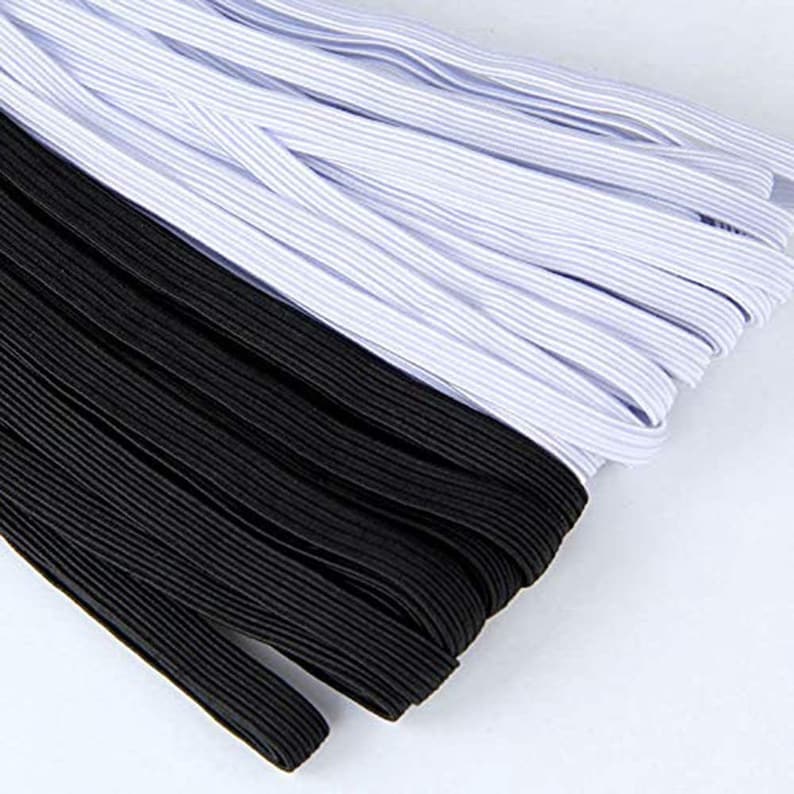 May include: A close-up of a bundle of black and white elastic. The elastic is folded in half and the white elastic is on top of the black elastic.