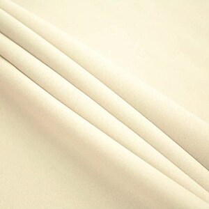 May include: A close-up of a smooth, off-white fabric with soft folds. The fabric has a subtle sheen and a luxurious feel.
