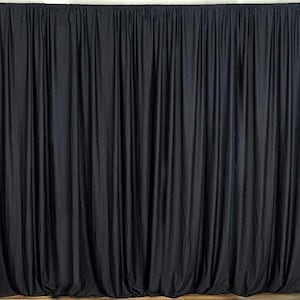 May include: Black stage curtains with a smooth, wrinkle-free fabric. The curtains are hung from a rod and are fully drawn, creating a solid black backdrop.