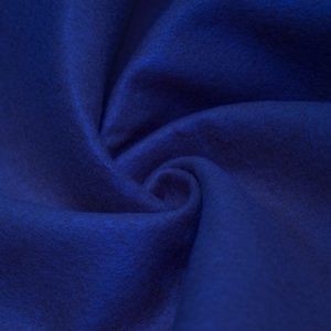 May include: A close-up of a deep blue fabric with a soft, textured surface. The fabric is folded and draped, creating a swirling pattern.