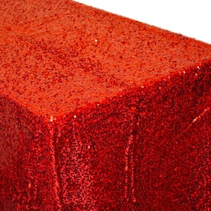May include: Red sequin tablecloth. The tablecloth is made of a soft, shimmery fabric with a subtle sheen. It is perfect for adding a touch of glamour to any event.