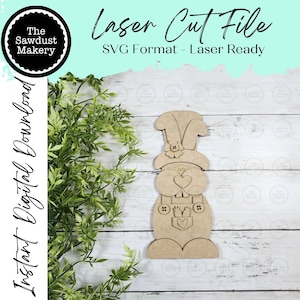 May include: A laser-cut wooden bunny decoration with a heart-shaped face and overalls. The design includes the text "Laser Cut File" and "SVG Format - Laser Ready". The image also features the text "Instant Digital Download" and the logo of "The Sawdust Makery".