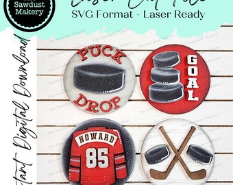 May include: Set of five laser cut SVG files for hockey themed crafts. The designs include a hockey puck with the words "Puck Drop", a stack of hockey pucks with the word "Goal", a hockey jersey with the number 85 and the name "Howard", and two hockey sticks crossed with two pucks.