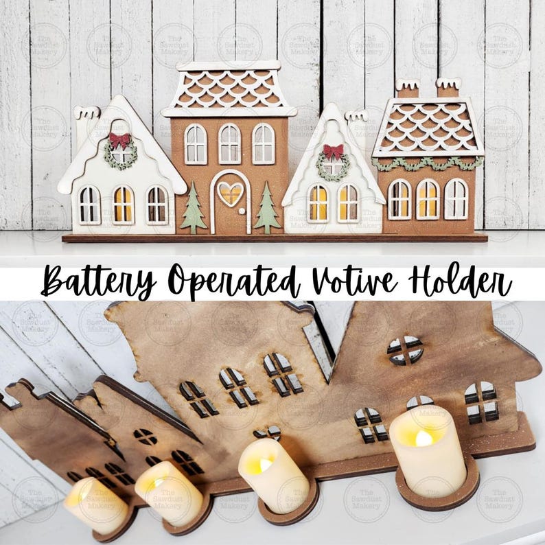 May include: A battery-operated votive holder shaped like a village of gingerbread houses. The houses are made of wood and painted in white, brown, and green. The text "Battery Operated Votive Holder" is displayed below the houses.