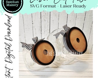 May include: Two clear glass jars with dark brown lids and a light brown centre. Each jar has a black and white checkered ribbon tied around the neck. The text "Laser Cut File" and "SVG Format - Laser Ready" are visible.