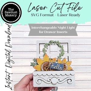 May include: A white laser-cut night light for drawer inserts, featuring a sunflower design with a "hello" tag. The design includes a window frame and a decorative scalloped drawer front. The text "Laser Cut File" and "Instant Digital Download" are also visible.