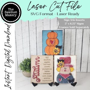 May include: Laser cut file for sign trio inserts. The image shows three decorative signs with autumn themes. One sign features stacked pumpkins, another lists autumn-related words, and the third depicts a scarecrow. The signs are approximately 12.7cm x 15.9cm.