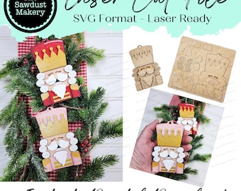 May include: Two laser cut nutcracker ornaments, one red and one pink, with gold glitter accents. The ornaments are ready to be assembled and decorated. The image also shows a laser cut file for the ornaments, which is in SVG format.