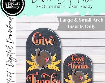May include: Two black arch-shaped laser cut files with the words "Give Thanks" and turkey illustrations. The larger one says "Give Thanks" and the smaller one says "Give Thanks". The text "Laser Cut File" and "SVG Format - Laser Ready" are also visible.