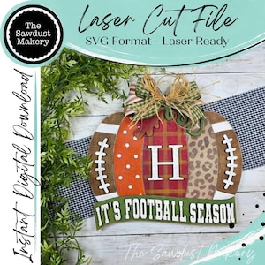 May include: A digital laser cut file for a pumpkin-shaped sign featuring football-themed patterns, a central letter H, and a banner with the text IT'S FOOTBALL SEASON. The design includes polka dots, plaid, and leopard print sections with a bow.