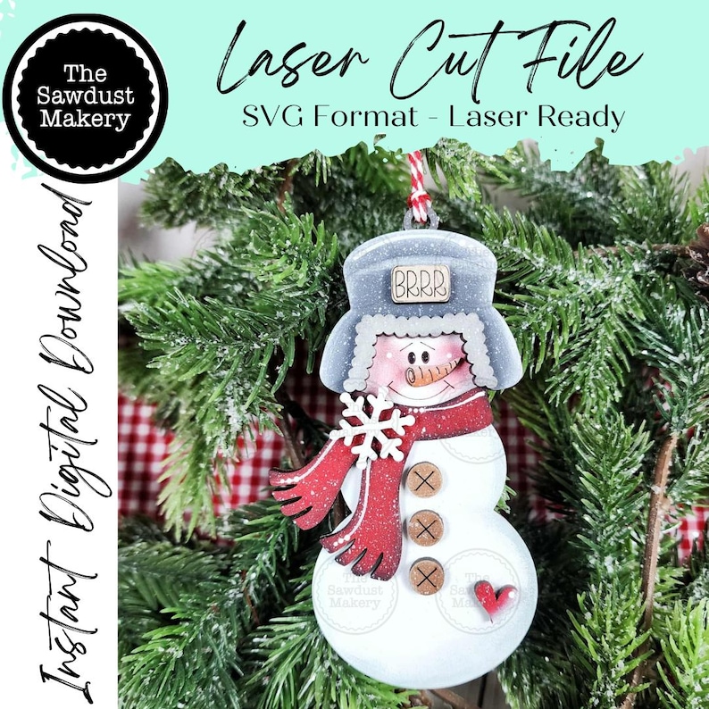 May include: A wooden snowman ornament with a red scarf, snowflake, and buttons. The snowman wears a gray hat with "BRRR" on it. The ornament is hanging in front of a Christmas tree. Text on the image says "Laser Cut File" and "Instant Digital Download."