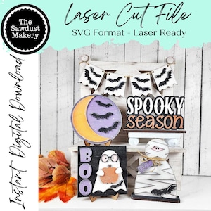 May include: A set of five Halloween-themed SVG cut files for laser cutting. The designs include a crescent moon with bats, a spooky season sign, a ghost holding a pumpkin, a boo sign, and a mummy with a creep sign.