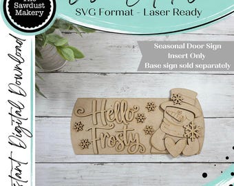 May include: A laser-cut wooden sign insert featuring the text Hello Frosty in a cursive font, accompanied by a snowman figure wearing a top hat and holding a heart, decorated with several small snowflake cutouts for a seasonal door sign.