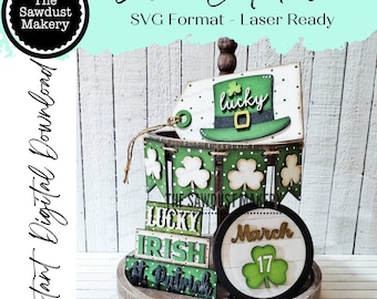 May include: A laser cut file for a St. Patrick's Day tiered tray decor. The design includes a lucky hat, shamrock banners, and blocks that read "Lucky", "Irish", and "St. Patrick". There is also a round sign that says "March 17".