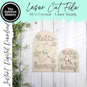 May include: Two wooden laser-cut signs with the words "Hello honey" and a bee design. The signs are light brown and feature a bee with heart-shaped wings and floral accents. The text "Laser Cut File" is at the top.