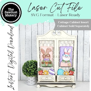 May include: A laser-cut file for a cottage cabinet insert, featuring two bunny portraits with glasses and bow ties. The cabinet has two drawers with Easter-themed decorations. The text reads "Laser Cut File" and "Instant Digital Download."